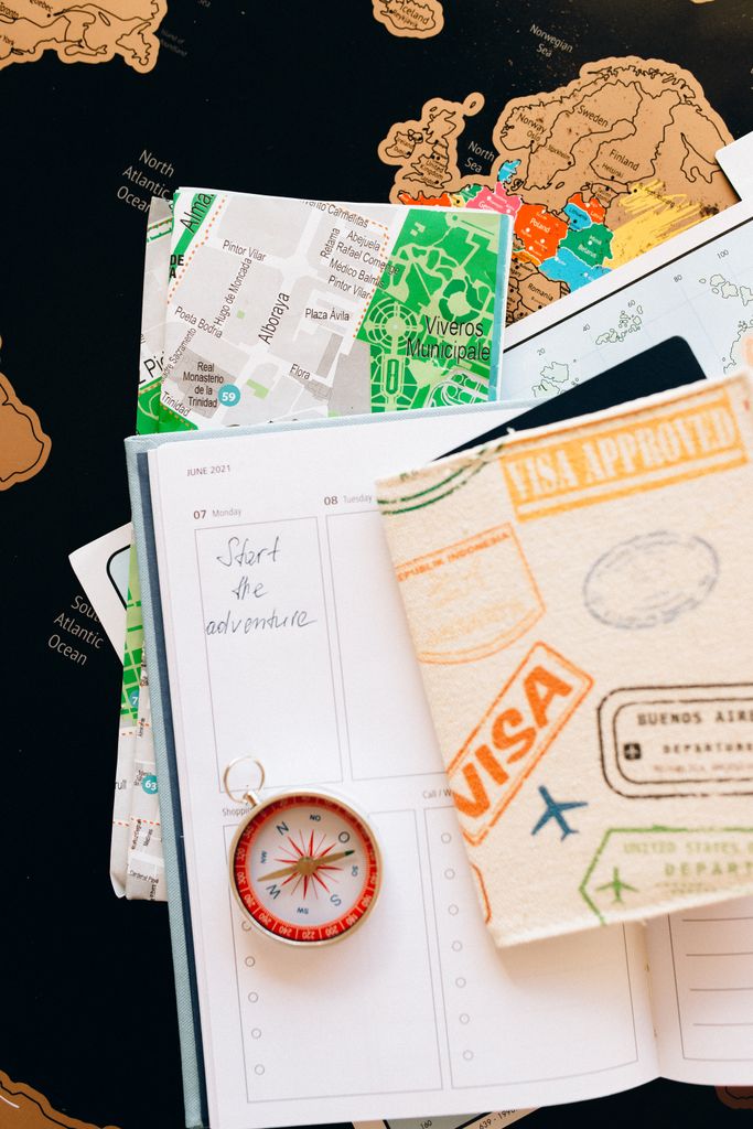 US E2 Visa Change of Status: My Honest Experience Switching Jobs on an L1 Visa 4 US visa status change: Flat lay of travel essentials including compass, notebook, and map for a journey.